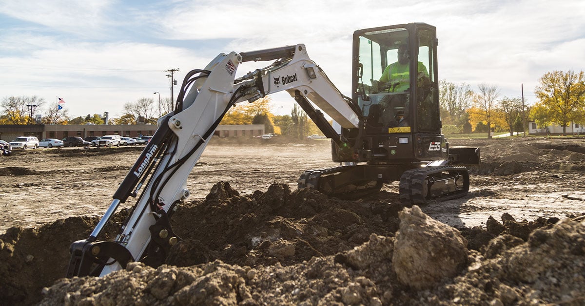 A Bobcat compact excavator working on a construction jobsite